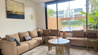 a living room with a couch and a table at Beachfront Villa in Dar Bouazza in Dar Bouazza
