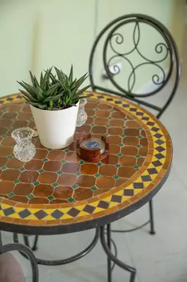 a table with a plant on top of it at Serene 2 BR Apt Steps from Parks & Casa Finance City in Casablanca