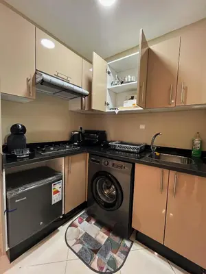 a kitchen with a washing machine and a washer at Modern studio near stadium Mohamed V AFCON 2025 in Casablanca