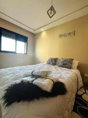 a bedroom with a large white bed with pillows at Modern studio near stadium Mohamed V AFCON 2025 in Casablanca