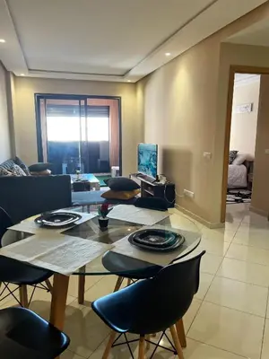 a living room with a table and chairs at Modern studio near stadium Mohamed V AFCON 2025 in Casablanca