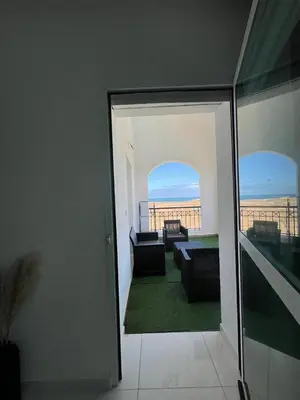 a room with a view of a living room at Mansouria Ricoflores beach vue mer et piscine in Mansouria