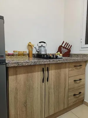 a kitchen with a counter top with a stove at Shams sidi rahal in Sidi Rahal