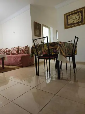 a living room with a table and two chairs at Shams sidi rahal in Sidi Rahal