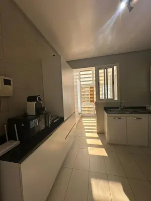 a kitchen with a sink and a counter top at Appartement luxueux prestigia in Rabat