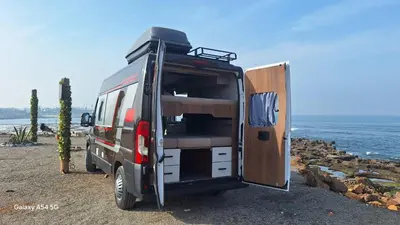 a camper van with its door open on a beach at J-L Camping Car Morocco in Casablanca
