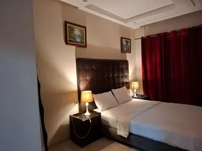 a bedroom with a bed and a red curtain at Emma's Luxury Studio 36 in Casablanca
