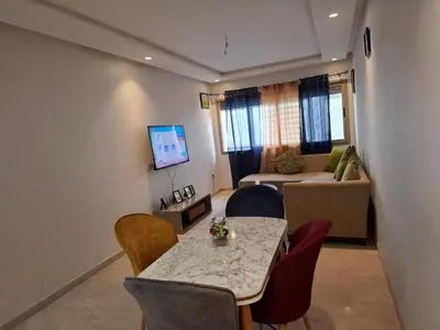 a living room with a table and chairs and a couch at Emma's Luxury Studio 36 in Casablanca