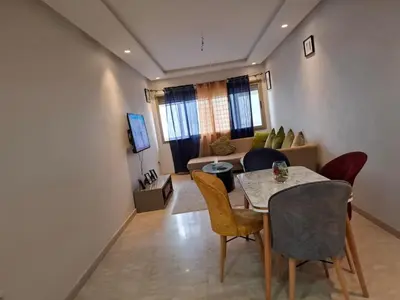 a living room with a table and chairs and a couch at Emma's Luxury Studio 36 in Casablanca