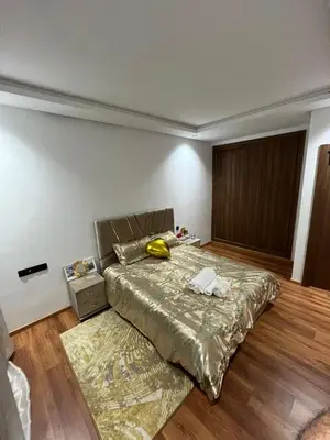 a bedroom with a bed with a gold bedspread at Aymen beach in Mansouria