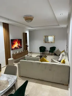 a living room with a couch and a fireplace at Aymen beach in Mansouria