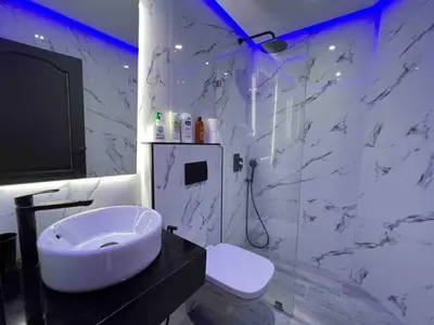a white bathroom with a sink and a toilet at Appt Centre ville Casablanca Maarif avec Terrasse in Casablanca