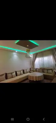 a living room with a couch and a table at Appartemment à Rabat Agdal Avenue de France in Rabat