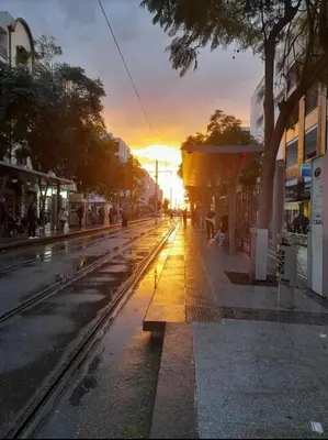 an empty street with a sunset in the background at Appartemment à Rabat Agdal Avenue de France in Rabat