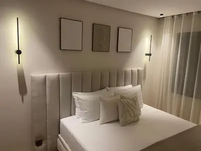 a bedroom with a bed with white sheets and pillows at Luxury apartment in Downtown Casablanca in Casablanca