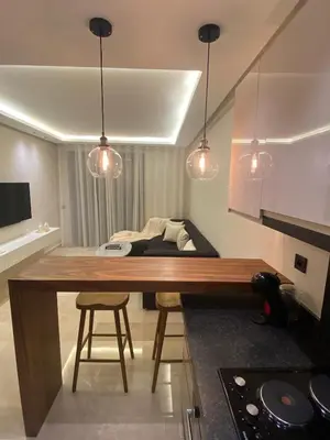 a kitchen with a table and two chairs and lights at Luxury apartment in Downtown Casablanca in Casablanca