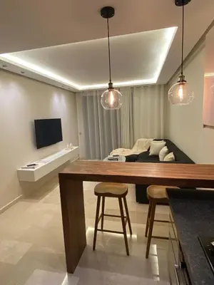 a living room with a table and a bed at Luxury apartment in Downtown Casablanca in Casablanca