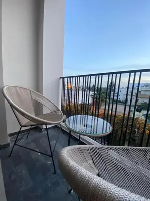 two chairs and a table on a balcony with a view at Luxury apartment in Downtown Casablanca in Casablanca