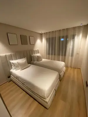 a hotel room with two beds and a window at Luxury apartment in Downtown Casablanca in Casablanca