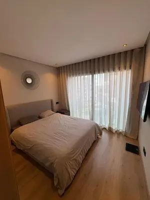 a bedroom with a bed and a large window at Studio Prestige CFC Casablanca in Casablanca