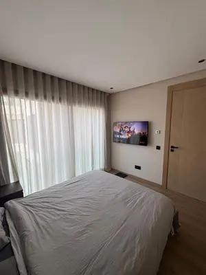 a bedroom with a large bed and a large window at Studio Prestige CFC Casablanca in Casablanca