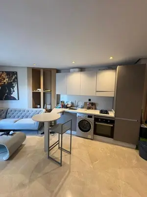 a kitchen and living room with a couch and a table at Studio Prestige CFC Casablanca in Casablanca