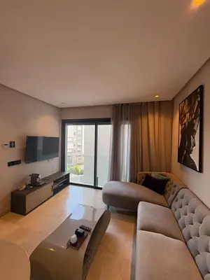 a living room with a couch and a television at Studio Prestige CFC Casablanca in Casablanca