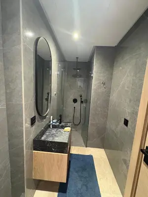 a bathroom with a sink and a shower with a mirror at Studio Prestige CFC Casablanca in Casablanca