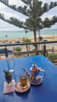 a blue table with a teapot and a cup of tea at Appartement en front de mer à 2 pas des Sablettes in Mohammedia