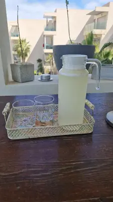 a container of milk on a tray on a table at Appartement en front de mer à 2 pas des Sablettes in Mohammedia