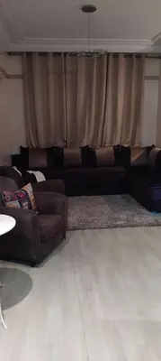 a living room with a couch and a rug at Appart cozy proche de casa voyageur in Casablanca