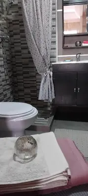 a bathroom with a toilet and a sink and a mirror at Appart cozy proche de casa voyageur in Casablanca