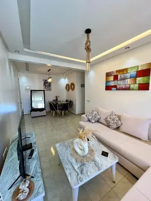 a living room with a couch and a table at Cosy chambre salon à 2 min harhoura in Temara