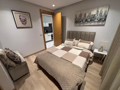 a bedroom with a bed and a chair in it at Cozy studio in ain diab in Casablanca