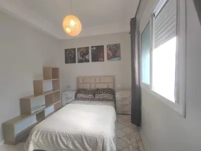 a small bedroom with a bed and a window at Mounia Moon in Casablanca