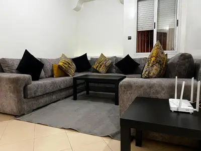 a living room with a couch with pillows on it at Apartment busway nearshore in Casablanca