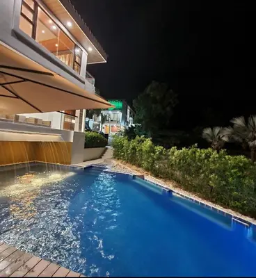 a swimming pool in front of a building at night at Villa alex33 in Casablanca