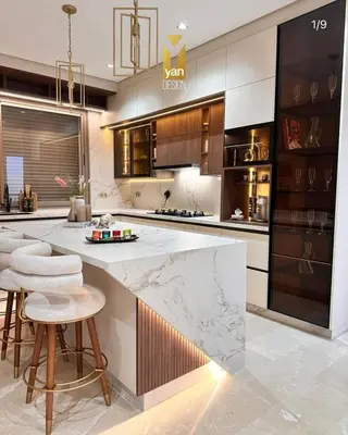 a kitchen with a large marble counter and stools at Villa alex33 in Casablanca