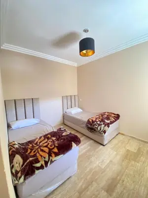 two beds sitting in a room with a ceiling at La perle bleu face à la mer Rabat in Rabat