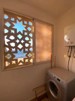 a laundry room with a window and a washing machine at La perle bleu face à la mer Rabat in Rabat