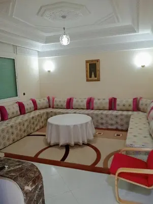 a living room with a couch with a table at Beautiful villa Near the beach in Mohammedia
