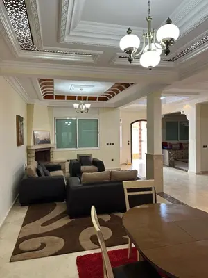 a living room with a couch and a table at Beautiful villa Near the beach in Mohammedia