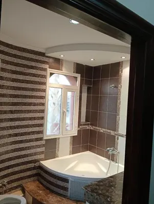a bath tub in a bathroom with a window at Beautiful villa Near the beach in Mohammedia