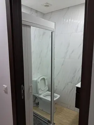 a bathroom with a white toilet in a room at Pierro in Maarif