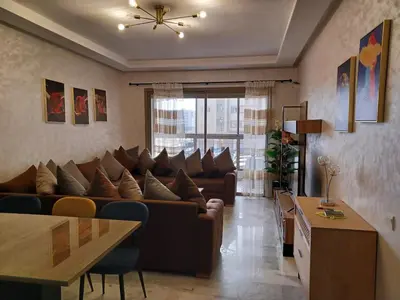 a living room with a couch and a table at Lovely & Comfy Long and Short Stay at Nouacer-Casa 2-Bedroom Apartment in Nouaceur