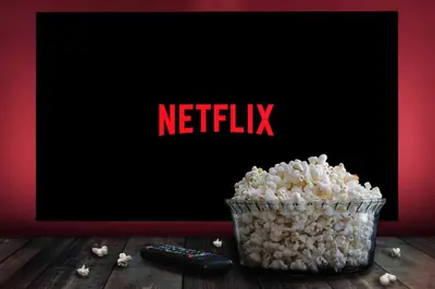 a container of popcorn and a remote control on a table at Lovely & Comfy Long and Short Stay at Nouacer-Casa 2-Bedroom Apartment in Nouaceur