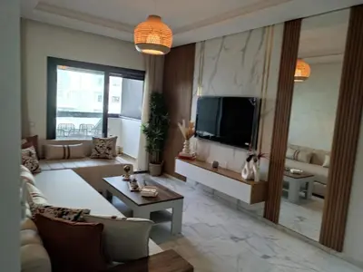 a living room with a couch and a tv at Beautiful apartment in the heart of Zenata in Aïn Harrouda