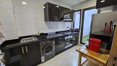 a kitchen with a sink and a washing machine at Apartment with terrace - Strategic location in Casablanca