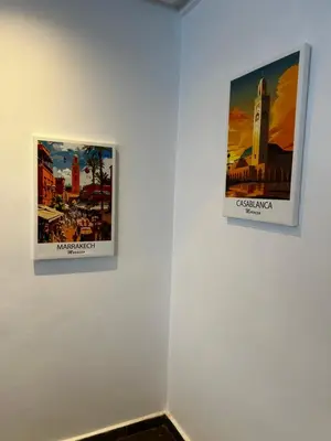 two pictures hanging on a white wall at Chez vous au cœur de Casablanca in Casablanca