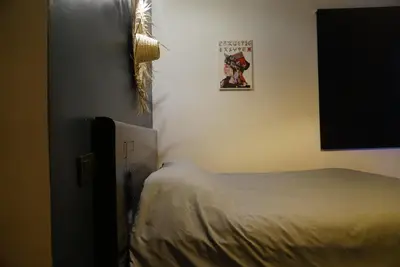 a bedroom with a bed and a picture on the wall at Chez vous au cœur de Casablanca in Casablanca